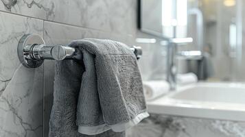 Close-up of Heated Rail with gray Towels in Bathroom with copy space. Modern heated towel rail on wall in a serene bathroom setting. photo