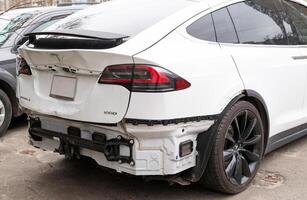 Kyiv, March 23, 2024. electric white Tesla Model X 100d car rear bumper damage photo