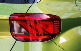 Rear running lights of Hyundai Venue green apple car close-up. Ukraine, Kyiv, April 10, 2024 photo