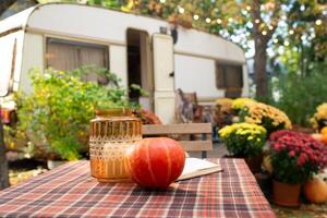 Pumpkin and decoration on garden table. Decorated garden with pumpkins and chrysanthemums. photo