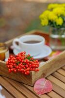 Rowan on a hot drink tray with fall decor. selective focus photo