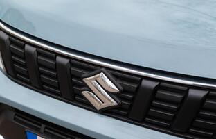 Kyiv,Ukraine. April 2024. Close-up view of logo of Suzuki letter S on a new blue car radiator grille photo