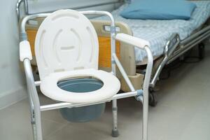 Flush toilet and shower chair in bathroom for old elder people. photo