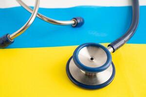 Stethoscope on Ukraine flag background, Business and finance. photo