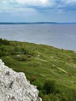 A stunning high-angle shot of a cliff along the Volga River bank, featuring the vast river against a scenic landscape photo