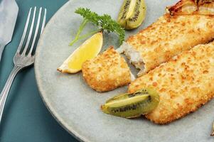 Baked pollock crusted fish fillets. photo