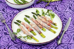 Yummy green asparagus in bacon. photo