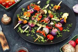 Tasty grilled vegetables on skewers, kebabs. photo