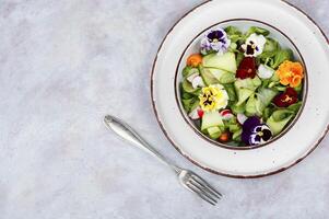 Vitamin vegetable salad with flowers. photo