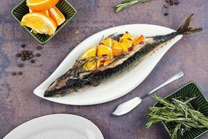 Roasted mackerel fish with oranges. photo