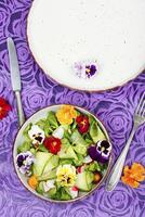 Vitamin vegetables salad with flowers. photo