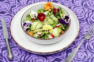 Salad of vegetables and flowers. photo