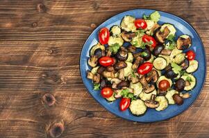 Baked seasonal vegetables with herbs. photo