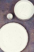 Empty plates on the table, kitchenware. photo