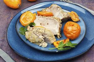 Roasted pork tenderloin meat with medlar. photo