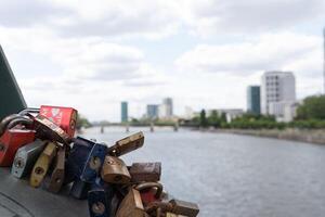 Bridge over the Main River in Frankfurt. Love locks hang on the fence of a pedestrian bridge in the German city of Frankfurt am Main. photo