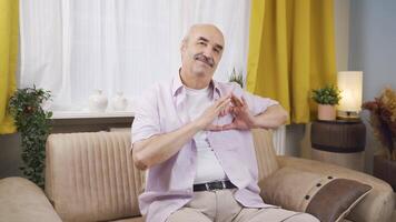 Man making heart symbol for camera. video