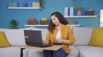 Young woman looking at laptop is happy and dancing. video