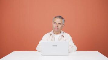 Man looking at laptop is thoughtful. video