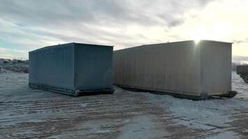 Unloading cargo containers in winter. Clip. Large containers are dragged ashore in winter. Unloading of containers of sea vessel video