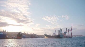 Big cargo ships are beautiful. Action. Seascape in which large water transports float against the background of the sea and the bright sun above. video