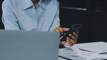 Asian woman holding smartphone, businesswoman using smartphone for social media and messaging with friends, using smartphone to send work email. Concepts of communication via the internet. video