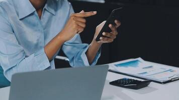 Asian woman holding smartphone, businesswoman using smartphone for social media and messaging with friends, using smartphone to send work email. Concepts of communication via the internet. video
