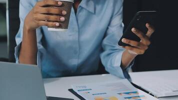 Asian woman holding smartphone, businesswoman using smartphone for social media and messaging with friends, using smartphone to send work email. Concepts of communication via the internet. video