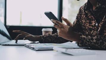 Asian woman holding smartphone, businesswoman using smartphone for social media and messaging with friends, using smartphone to send work email. Concepts of communication via the internet. video