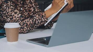 Close up Business woman using calculator and laptop for do math finance on wooden desk, tax, accounting, statistics and analytical research concept video