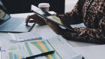 Close up Business woman using calculator and laptop for do math finance on wooden desk, tax, accounting, statistics and analytical research concept video