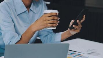 Asian woman holding smartphone, businesswoman using smartphone for social media and messaging with friends, using smartphone to send work email. Concepts of communication via the internet. video