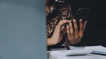 Asian woman holding smartphone, businesswoman using smartphone for social media and messaging with friends, using smartphone to send work email. Concepts of communication via the internet. video