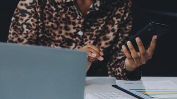 Asian woman holding smartphone, businesswoman using smartphone for social media and messaging with friends, using smartphone to send work email. Concepts of communication via the internet. video