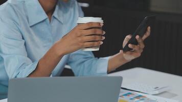 Asian woman holding smartphone, businesswoman using smartphone for social media and messaging with friends, using smartphone to send work email. Concepts of communication via the internet. video