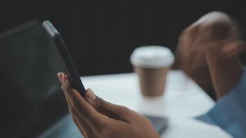 Asian woman holding smartphone, businesswoman using smartphone for social media and messaging with friends, using smartphone to send work email. Concepts of communication via the internet. video