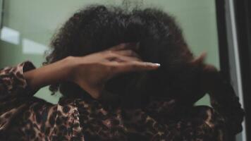 Close up of a woman twisting afro hair. Hair weaving video