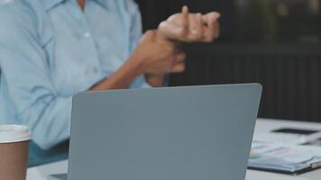 Close up Business woman using calculator and laptop for do math finance on wooden desk, tax, accounting, statistics and analytical research concept video