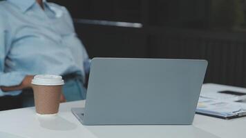 Close up Business woman using calculator and laptop for do math finance on wooden desk, tax, accounting, statistics and analytical research concept video