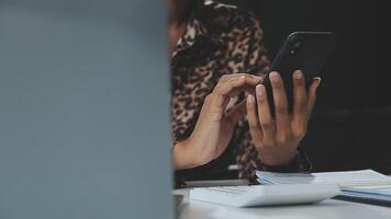 Asian woman holding smartphone, businesswoman using smartphone for social media and messaging with friends, using smartphone to send work email. Concepts of communication via the internet. video