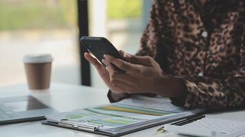 Asian woman holding smartphone, businesswoman using smartphone for social media and messaging with friends, using smartphone to send work email. Concepts of communication via the internet. video