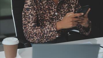 Asian woman holding smartphone, businesswoman using smartphone for social media and messaging with friends, using smartphone to send work email. Concepts of communication via the internet. video