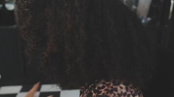 Close up of a woman twisting afro hair. Hair weaving video