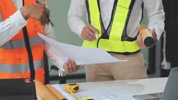 civil ingeniero equipos reunión trabajando juntos vestir trabajador cascos casco de seguridad en construcción sitio en moderno ciudad. capataz industria proyecto gerente ingeniero trabajo en equipo. asiático industria profesional equipo. video