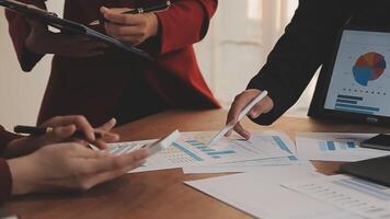 Financial analysts analyze business financial reports on a digital tablet planning investment project during a discussion at a meeting of corporate showing the results of their successful teamwork. video