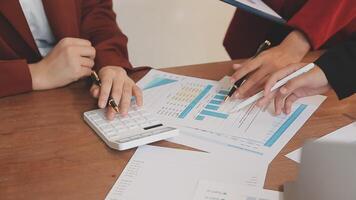 Financial analysts analyze business financial reports on a digital tablet planning investment project during a discussion at a meeting of corporate showing the results of their successful teamwork. video