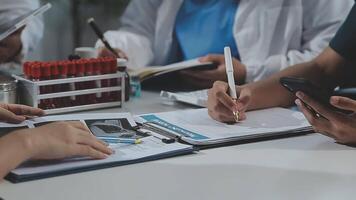 medico, incontro e il computer portatile per squadra nel ufficio nel discussione, di brainstorming e pianificazione. medico, infermiera e computer su scrivania, lavoro di squadra o laboratorio per dati analitica. video