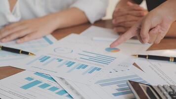 Financial analysts analyze business financial reports on a digital tablet planning investment project during a discussion at a meeting of corporate showing the results of their successful teamwork. video