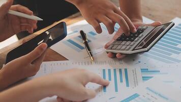 Financial analysts analyze business financial reports on a digital tablet planning investment project during a discussion at a meeting of corporate showing the results of their successful teamwork. video