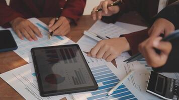 Financial analysts analyze business financial reports on a digital tablet planning investment project during a discussion at a meeting of corporate showing the results of their successful teamwork. video